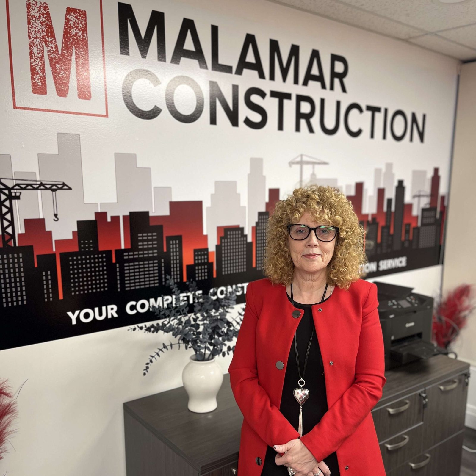 Gillian Cuthbert, Co-Owner and CEO of Malamar Construction, in a red blazer
