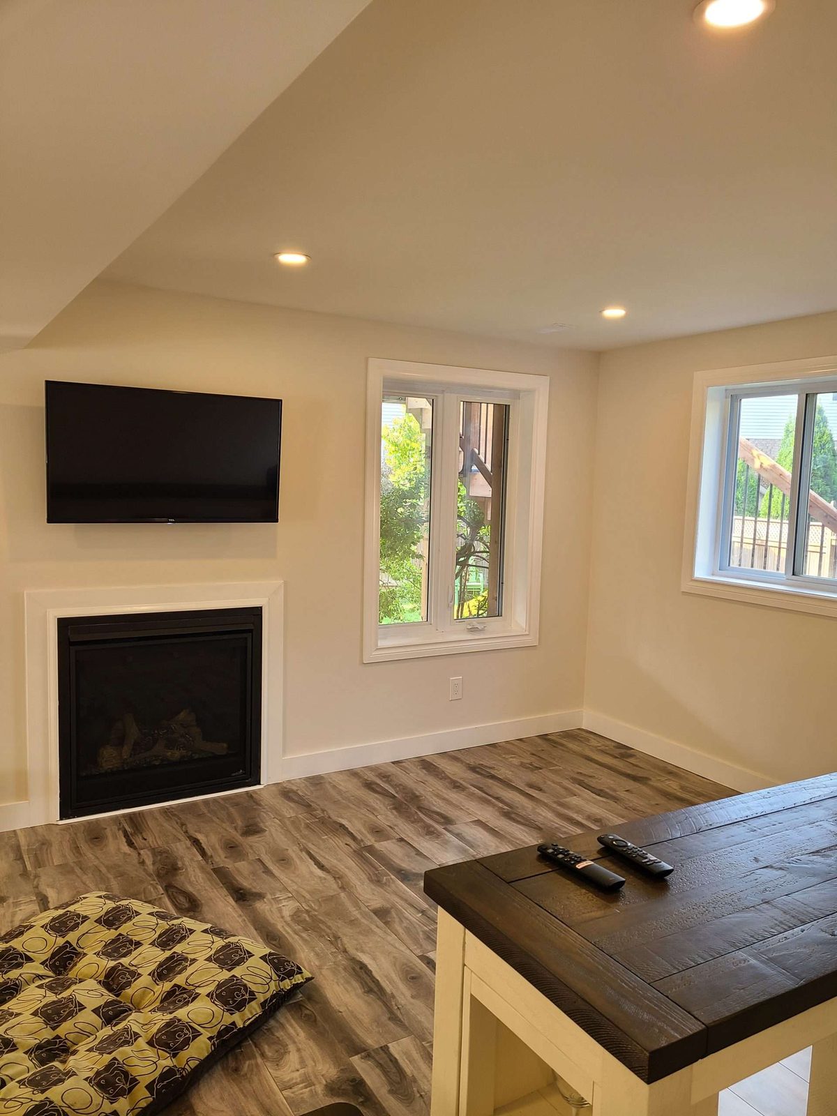 Renovated living room with a fireplace, TV and patterned tile